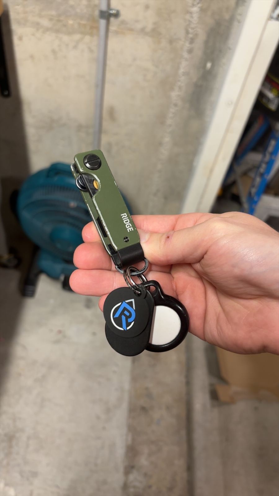 The finished printed logo keychain held in hand with keys attached